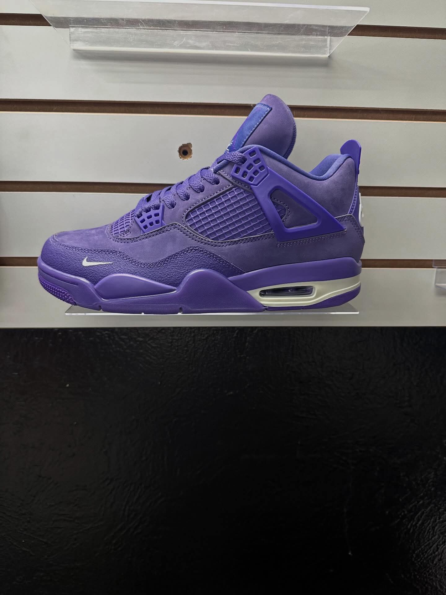 Purple suede Air Jordan 4 on display